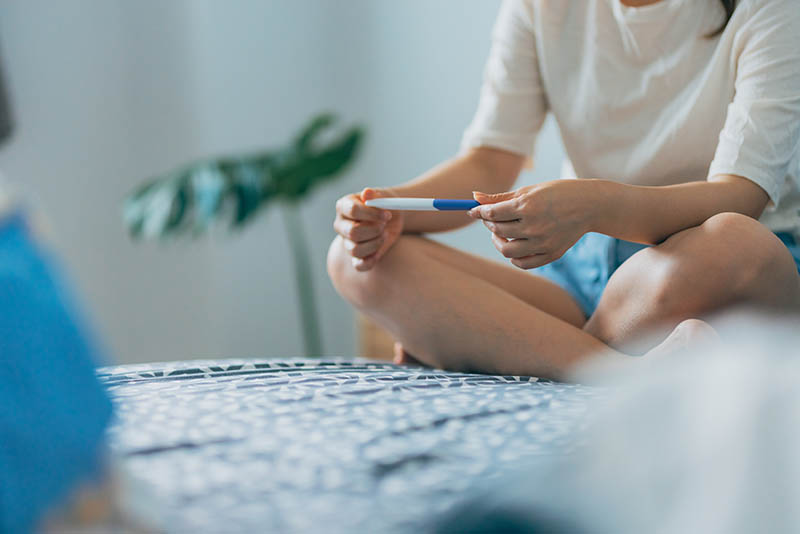 Woman checking pregnancy test
